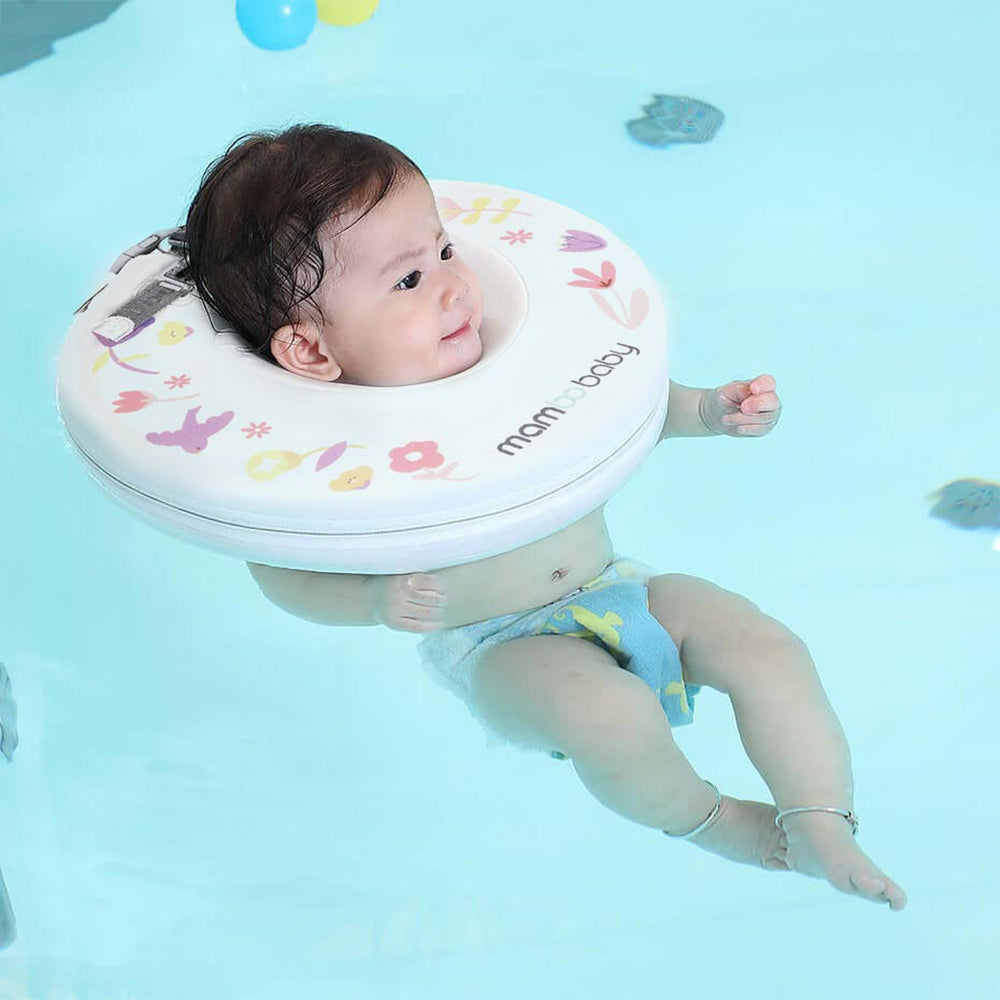 A newborn safely exploring water movements in a Mambobaby™ Neck Float during a spa session.