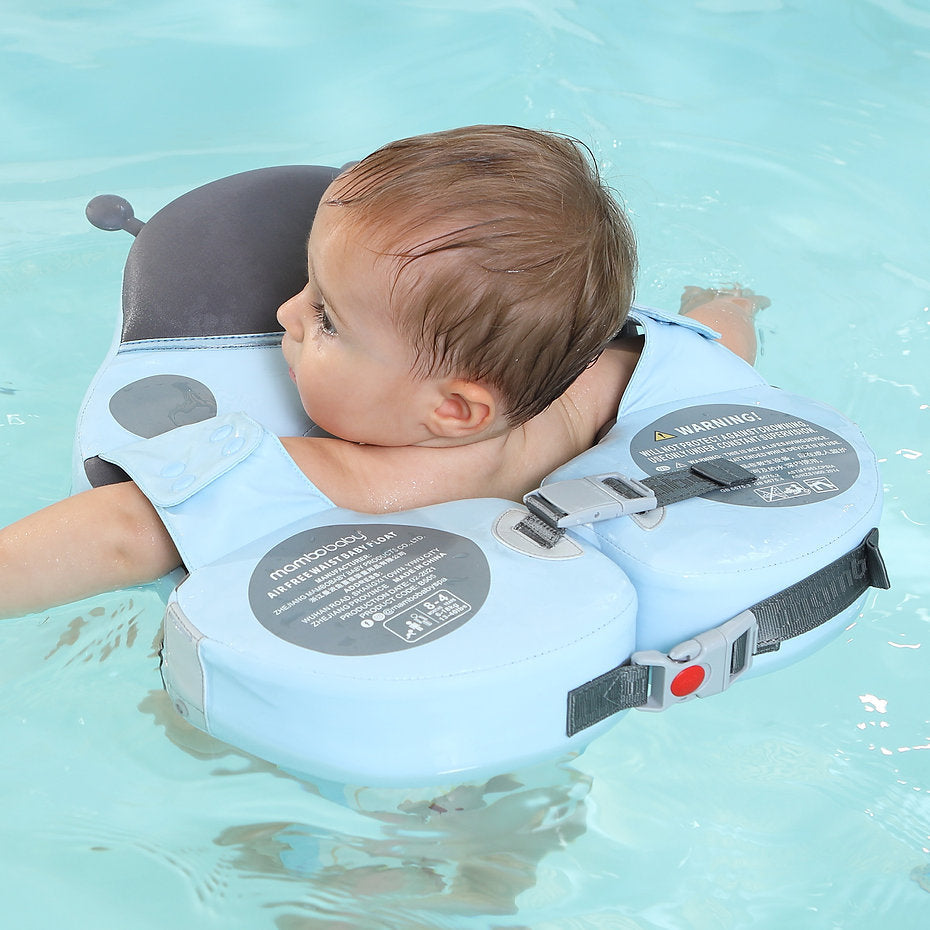 A toddler enjoying a holiday swim in the Mambobaby™ Ladybug Shoulder Float, promoting water confidence and leg movement.